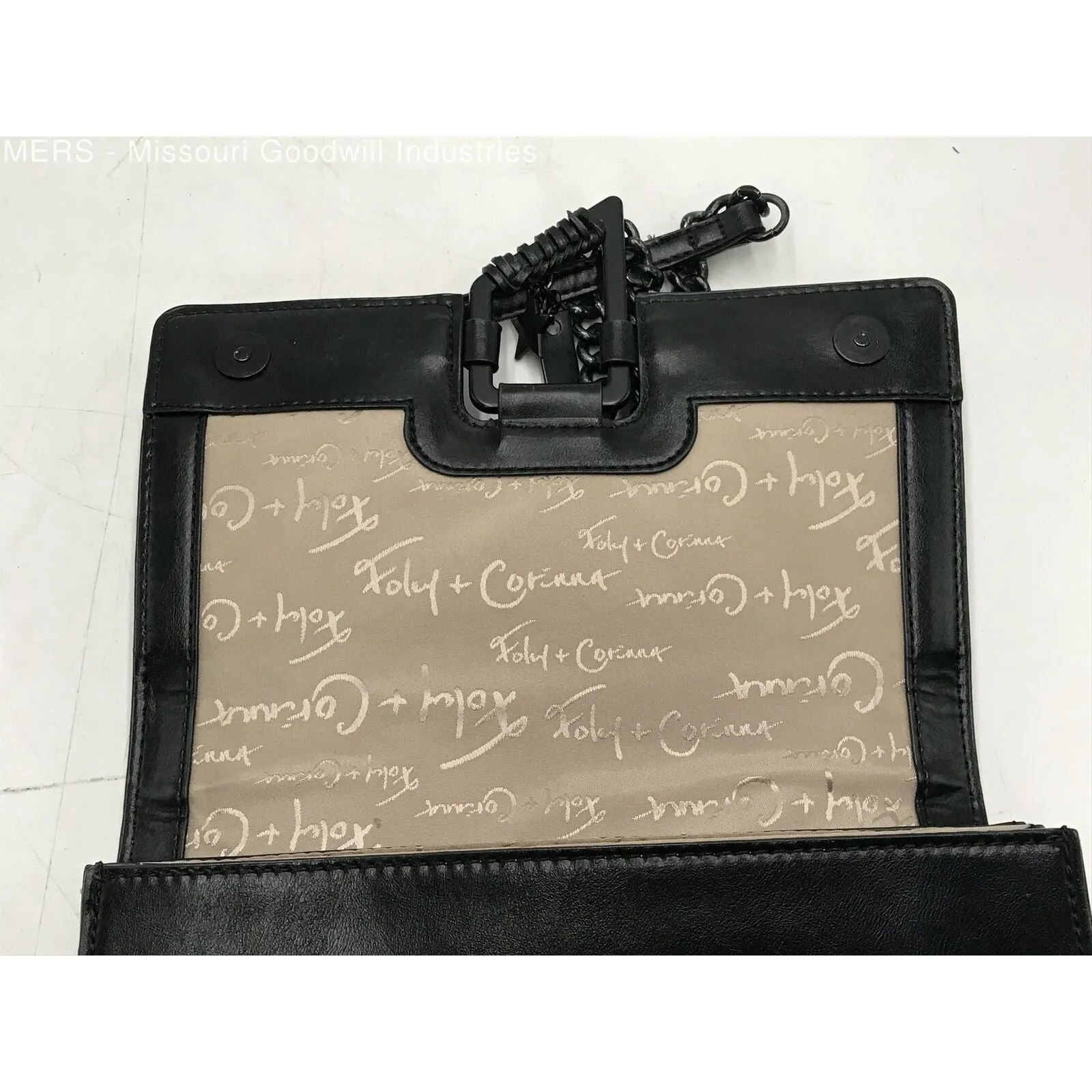 Foley & Corina, black leather, crossbody purse with an envelope top, a back zip pocket and lots of interior pockets.